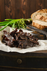 Closeup view of heap of jerky venison on wrapping paper