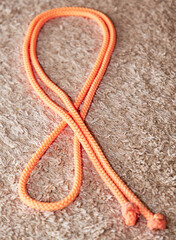 The jump rope is lying on the floor for private rhythmic gymnastics classes