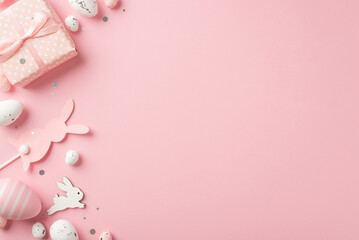 Fototapeta na wymiar Top view photo of easter decorations giftbox shiny confetti easter bunnies pink and white easter eggs on isolated pastel pink background with empty space