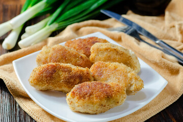 Chicken patties or fish cakes fried in breadcrumbs