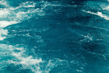 Fototapeta na wymiar Stormy blue Aare river in Switzerland, close-up.