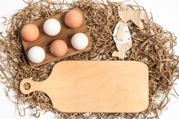 Easter mockup wood cutting board with bunny and easter eggs on wooden bowl on white background....