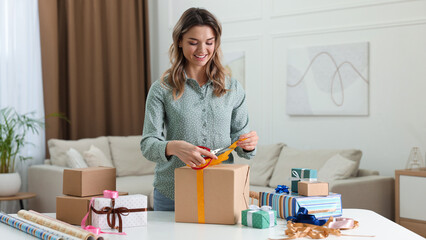 Beautiful young woman wrapping gift at table in living room