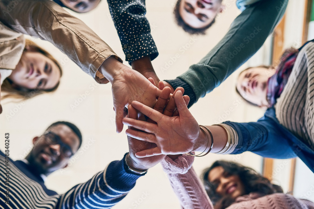 Poster theres power in unity. low angle portrait of a group of young friends.