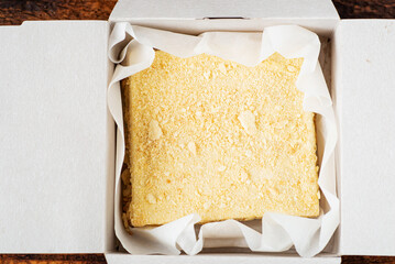 Napoleon cake in a cardboard box. Sweet gift. Delivery of confectionery. Top view.