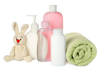 Obraz na płótnie Canvas Bottles of baby cosmetic products, towel and toy bunny on white background