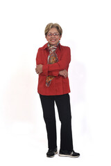 front view of a full portrait of happy senior woman with shirt and pants looking at camera on white background