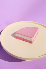 piece of ice-cream cake liying on white plate on soft background