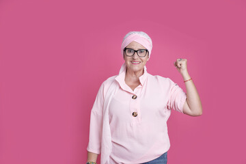 Cheerful sick woman showing bicep for positive attitude