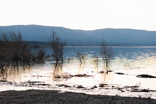 Shore of river against mountain ridge