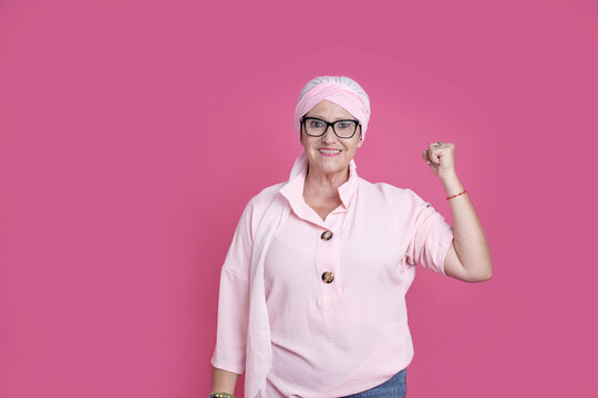 Cheerful sick woman showing bicep for positive attitude