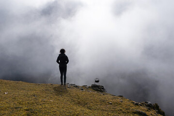 Hiker woman on misty mountain.