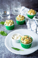Spinach Feta cheese breakfast muffins with fresh spinach leaves