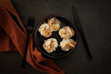 Stuffed eggs with tuna and mayonnaise sauce on dark background