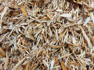 Small pile of wood chips background, top view. Waste from the woodworking industry, fuel and raw materials for heating solid fuel industrial boilers on wood chips