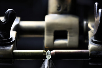0.55 ct octahedral diamond crystal clamped in a vintage diamond cutting machine