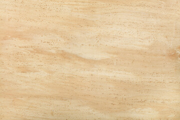 Beige wall texture with spotted corrugated surface.