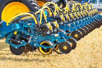 The wheel mechanism of a multi-row seeder as a hitch to a tractor on the background of an...