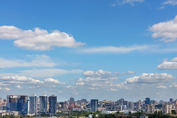 Cityscape with new high rise residential buildings under a summer cloudy sky.