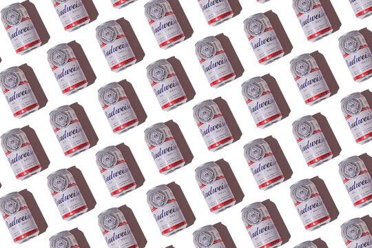 Budweiser american beer cans pattern with hard shadow on white background. Alcohol, brewery, industry, factory and bar concept.