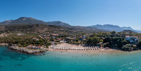 Fototapeta na wymiar Greece, sandy beach, aerial drone view. People swim and relax at Stoupa beach Mani, Peloponnese.