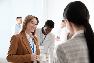 Group of people chatting during coffee break indoors