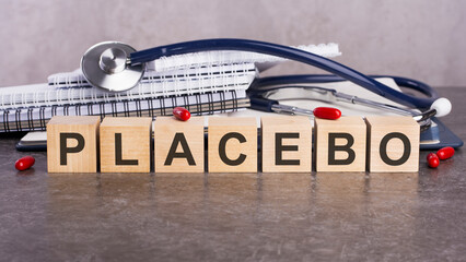 PLACEBO text on wooden blocks, medical concept, gray background