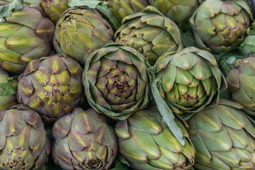 Fototapeta premium Artichokes closeup, organic food, background of artichokes, food background.