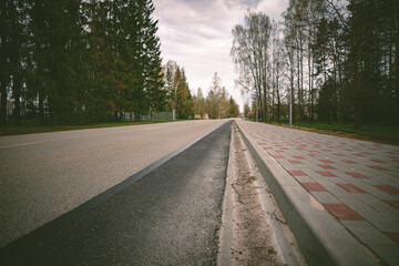 Fototapeta premium asphalt road, concrete brick pavement, perspective