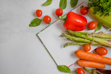 Fototapeta na wymiar notepad, vegetables and fruit on a light background, diet plan