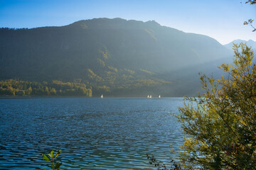 Sailboats on fantastic Bohinj lake in Triglav national park in Slovenia: mountains, pure water and reflection
