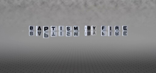 baptism by fire word or concept represented by black and white letter cubes on a grey horizon...