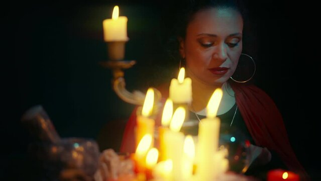 Fortune-teller laying out tarot cards and smiling, predicting future, mystery
