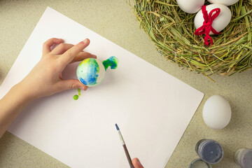 child paints easter eggs, preschooler prepare for easter celebration