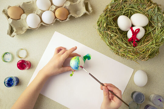 child paints easter eggs, preschooler prepare for easter celebration
