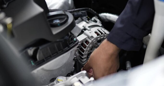 Close up of Asian Man mechanic inspection shine a torch car engine checking bug in engine. Service maintenance insurance with car engine. Car service concept.