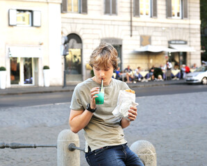 Lifestyle portrait of a young man, relaxing and having lunch