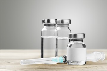 Bottles with covid-19 vaccine remedy for illness epidemic medicine drug stands on table
