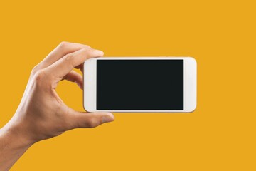 Human hand using smartphone with a blank screen