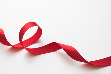 loops of red  ribbon on gray text place .