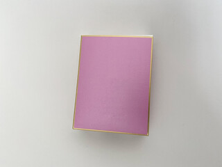 Perfume bottle from a pink box on a white isolated background