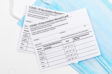 Coronavirus vaccination record card. Protective mask divided into two parts. Concept of defeating Covid-19 - Image