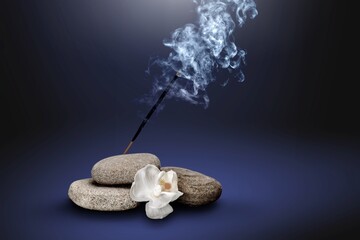sacred incense stick on a background with a fire and a lot of smoke. The concept of incense, healing, meditation, relaxation, tranquility, calming.