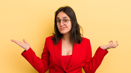 young hispanic woman feeling puzzled and confused and doubting. business concept
