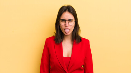young hispanic woman feeling disgusted and irritated and tongue out. business concept