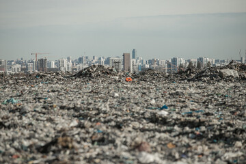 mountain of garbage on the background of the city