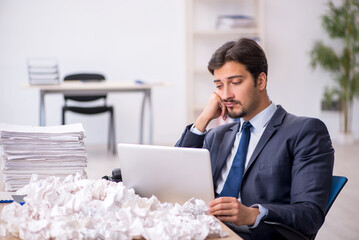 Young male employee in brainstorming concept