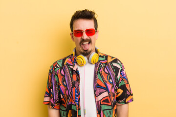 with cheerful and rebellious attitude, joking and sticking tongue out. listening music concept