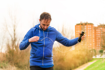 Fototapeta premium Caucasian Spanish male putting on his helmet for a morning run.