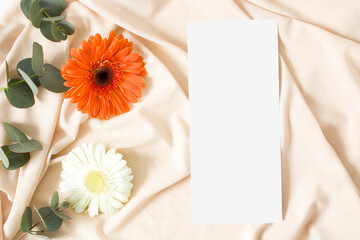 Mockup menu card with eucalyptus leaves on the nude fabric